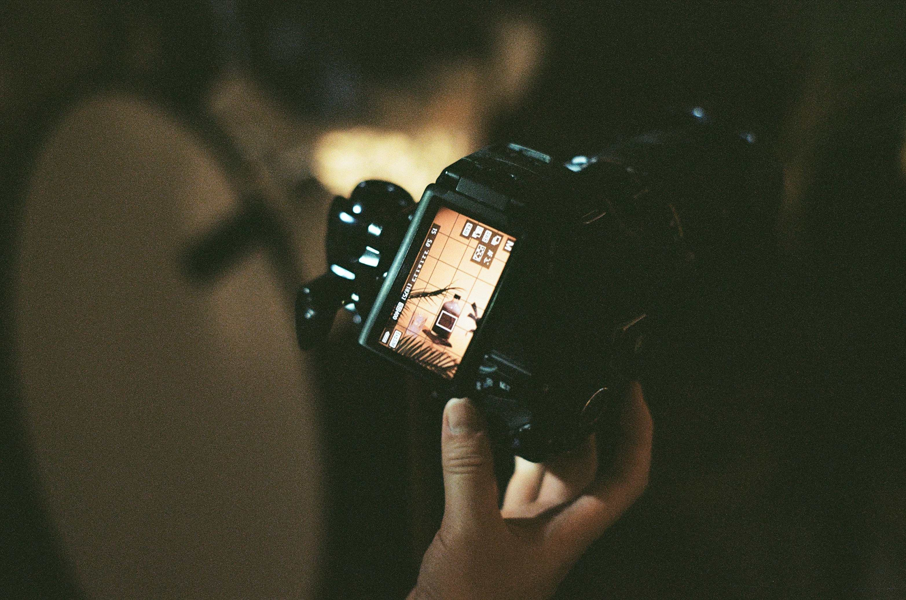 person holding black dslr camera